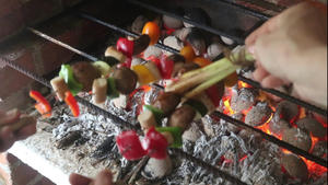 Grill the vegan sausage skewers on charcoal fire until fragrant