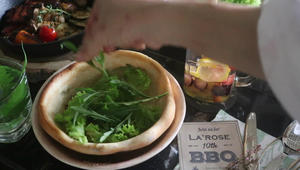 Place lettuce and sesame leaves in the bread bowl