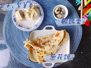 Breakfast of purple sweet potato rolls, steamed buns, and quail egg scallion pancakes.