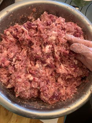 While mixing, slowly pour in the chilled scallion and ginger water, adding a small amount of the water to dissolve the sweet potato starch before combining with the meat.