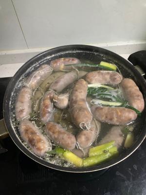 At this point, place into a pot of cold water for slow cooking. Simmer on medium-low heat for 1 hour, ensuring the water does not boil and the lid remains off! A too high flame leading to boiling can burst the sausages.