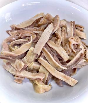 After cooking, remove the tripe and let it cool slightly, then slice or cut it into strips against the grain.