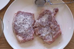 Use a small sieve to dust flour on both sides of the pork.