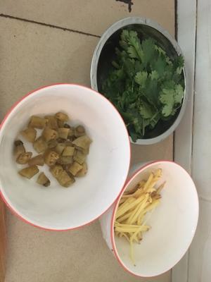 Julienne the ginger, cut the pickled peppers into sections, and chop the cilantro.