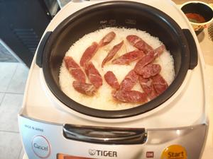 In a rice cooker, cook the Chinese sausage over the rice.