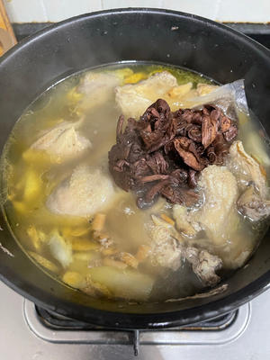 After simmering the chicken broth on low heat for about two hours, add the mushrooms and some salt. Cook for an additional 15 to 30 minutes.