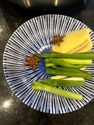 Add the scallions, ginger, and star anise, and stir-fry.