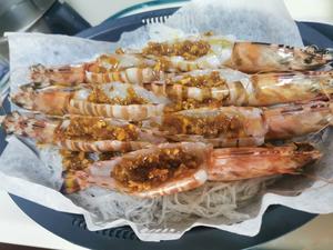 Spread some garlic sauce on the noodles, and brush some inside each shrimp.