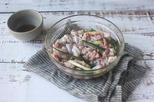 Cut the bullfrog into small pieces and marinate with ginger slices, scallions, cooking wine, a pinch of salt, and pepper for half an hour.