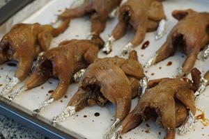 Line a baking tray with aluminum foil and baking paper. Wrap the tips of the quail legs and wings in foil to prevent burning.