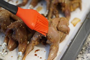 Brush the quails with a mixture of honey and water.