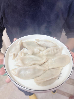 Serve the steaming hot dumplings that emit a delightful aroma.