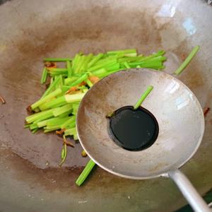 Heat oil in the pan and sauté the chopped scallions, ginger, and garlic. Add the small celery and stir-fry on high heat, adding a teaspoon of soy sauce.