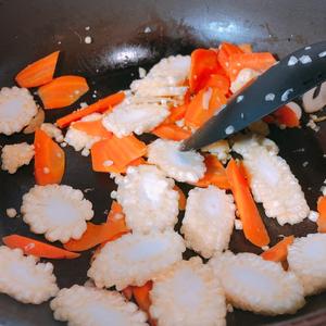 Add the baby corn and continue to stir-fry.