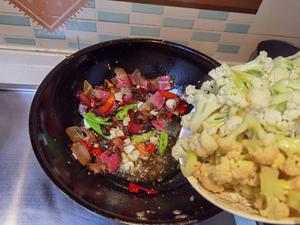 Once fragrant, add the cauliflower back into the pan.