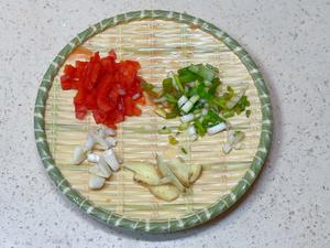 Dice the red pepper, chop the scallions, minced the garlic, and slice the ginger.